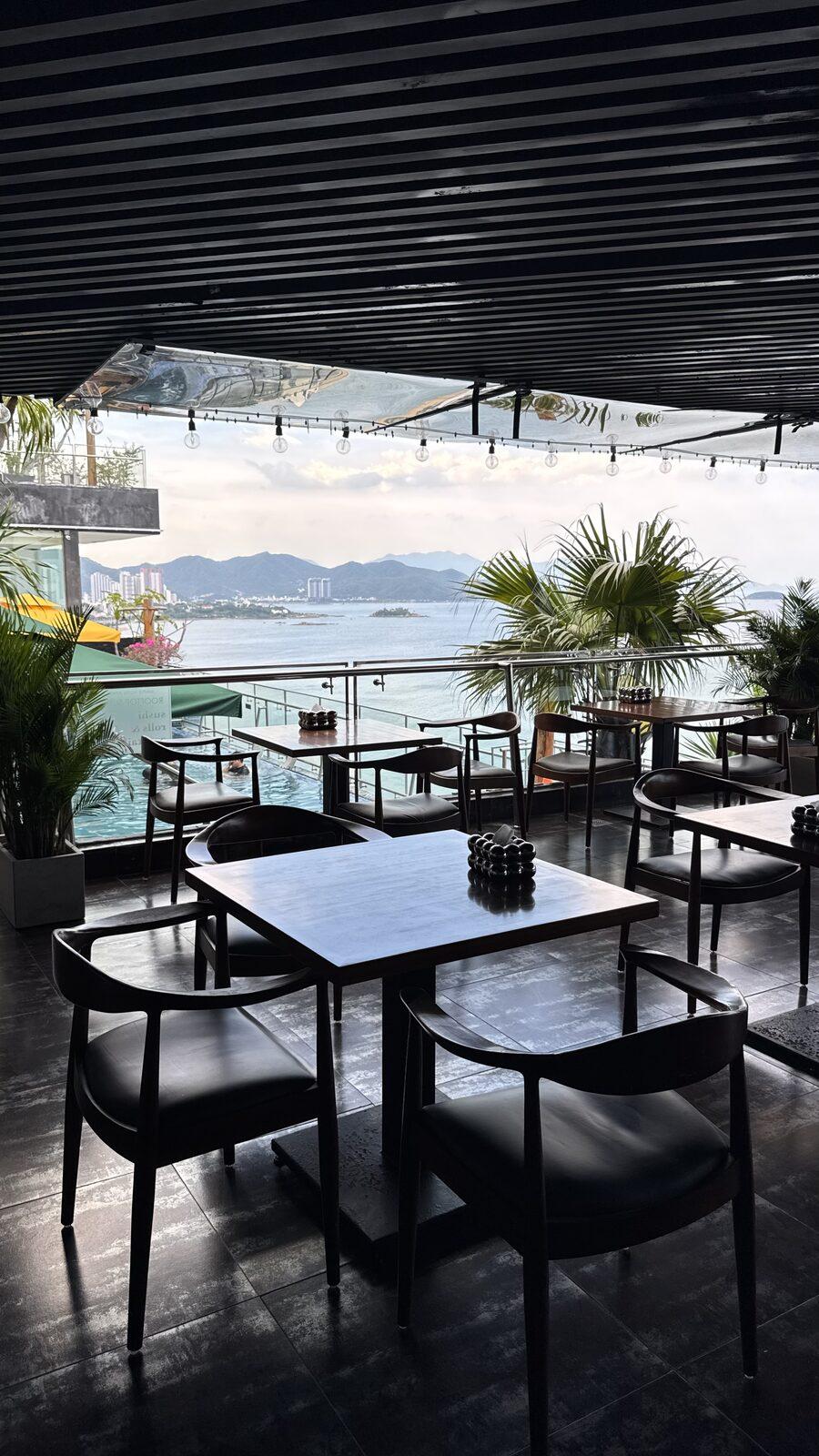 M Bar terrace tables with the bay in the background
